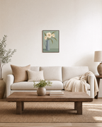 Ivory Pitcher Blooms Studio edition unframed print is shown framed for styling in a living room; Frame not included
