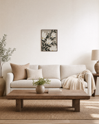 Uneven Magnolias white magnolia wall art: unframed print is shown framed for styling in a living room; frame not included