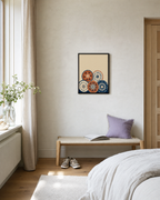 Five Beach Discs unframed print is shown framed for styling in a bedroom sitting; frame not included