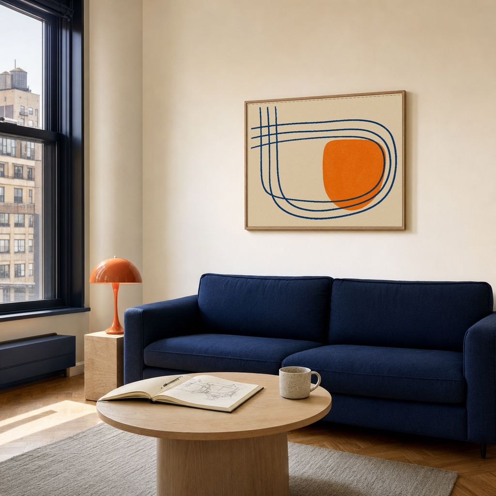 Orange Break navy line orange wall art: unframed print is shown framed for styling in a cream and navy apartment living room; frame not included