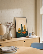 Twin Orange Sprigs Vertical unframed print is shown framed for styling in a dining console; frame not included