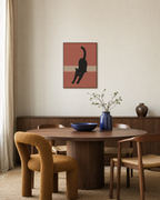 After Nap Cat stretching black cat print: unframed print is shown framed for styling in a dining room; frame not included