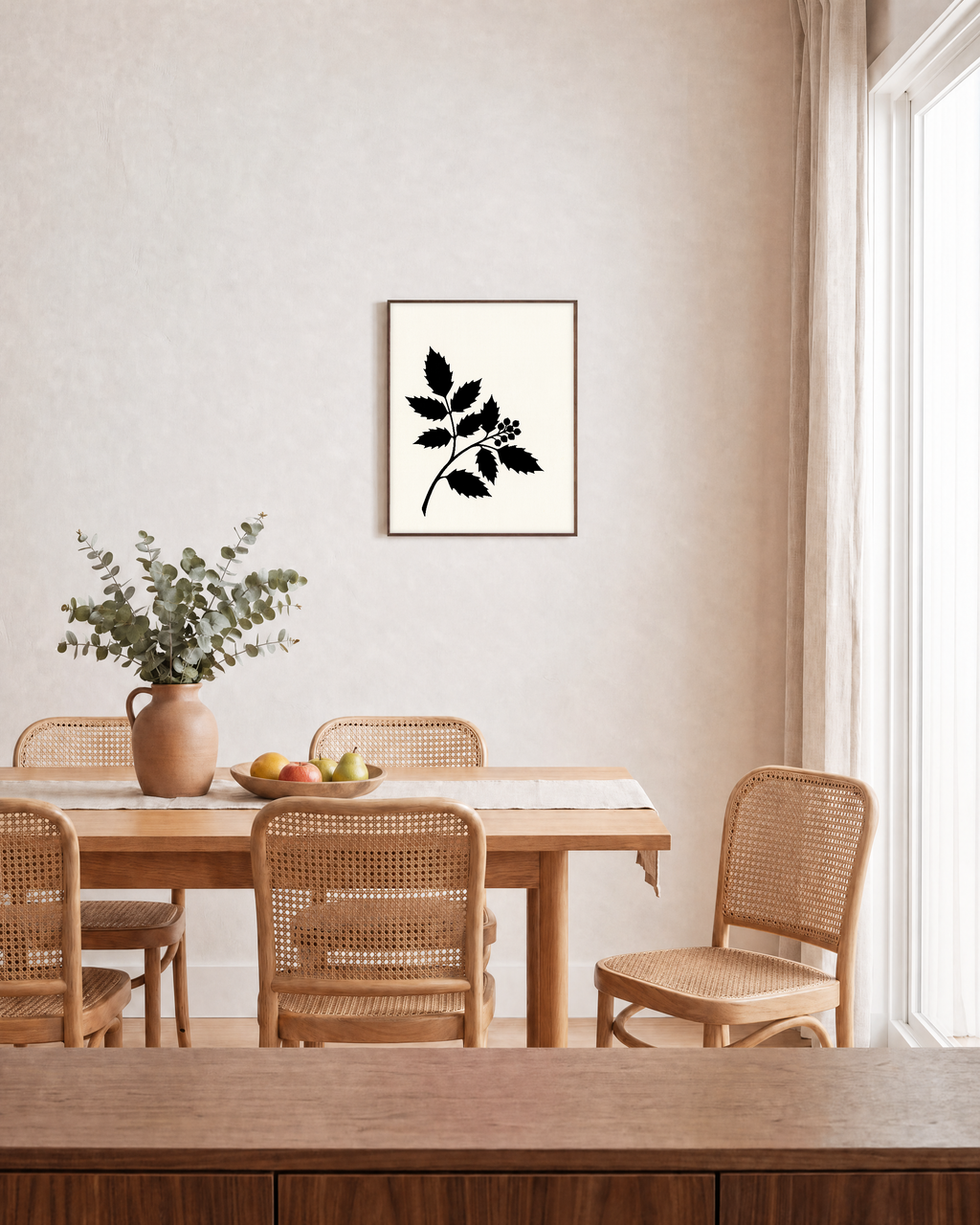 Black Leaf Sprig unframed print is shown framed for styling in a dining room; frame not included