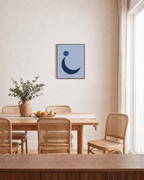 Navy Crescent with Blue Circle blue moon wall art: unframed print is shown framed for styling in a dining room; frame not included