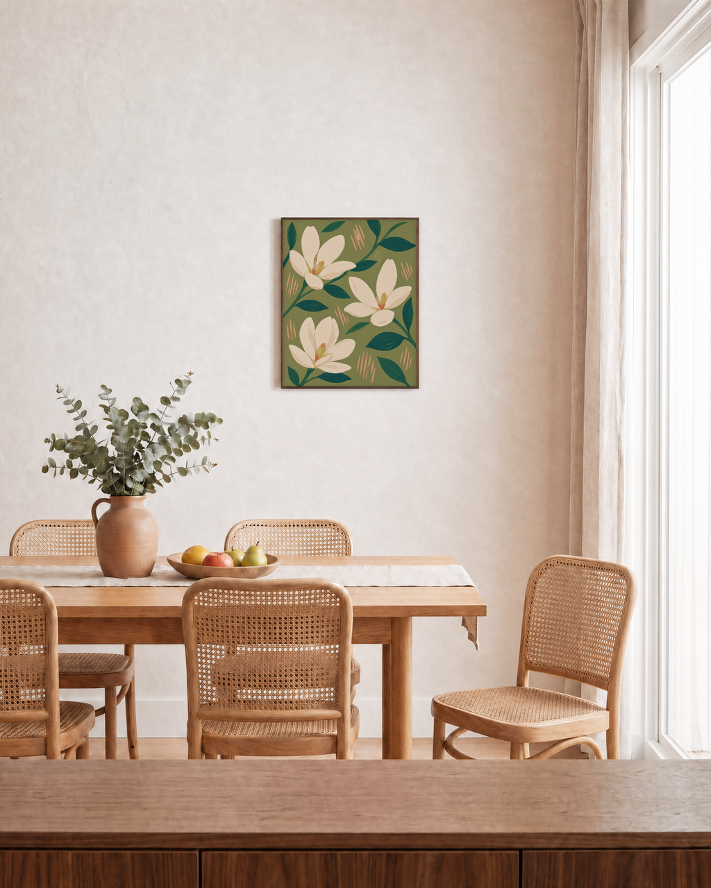 Three Magnolias On Olive Field unframed print is shown framed for styling in a dining room; frame not included