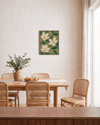 Three Magnolias On Olive Field unframed print is shown framed for styling in a dining room; frame not included