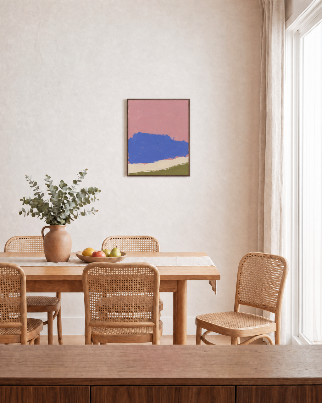 Blue Landform Over Pink Bands blue and pink abstract wall art: unframed print is shown framed for styling in a dining room; frame not included