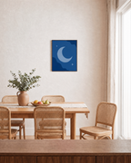 Crescent Moon with Two Stars crescent moon and stars wall art print: unframed print is shown framed for styling in a dining room; frame not included