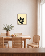 Black Leaf Sprig unframed print is shown framed for styling in a dining room; frame not included