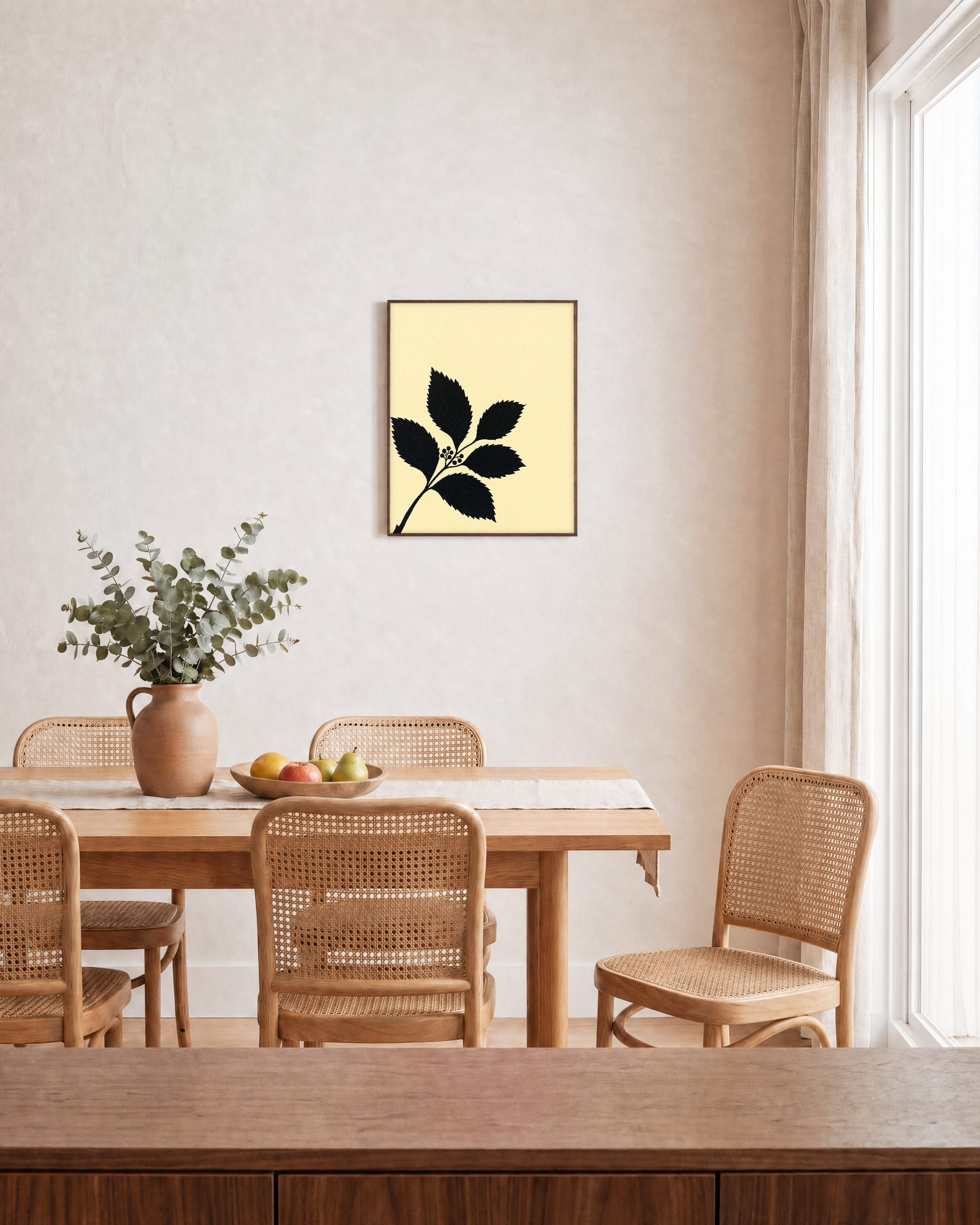 Black Leaf Sprig unframed print is shown framed for styling in a dining room; frame not included