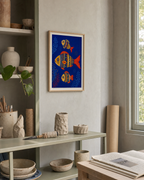 Three Folk Fish unframed print is shown framed for styling in a ceramics studio shelf; frame not included