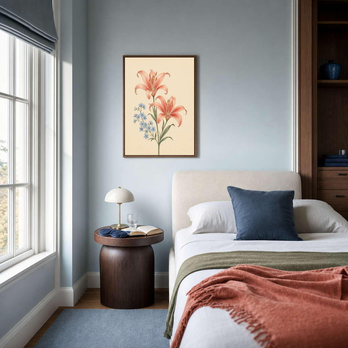 Blue Bloom Chaperone coral lily spray wall art: unframed print is shown framed for styling in a quiet blue bedroom; frame not included