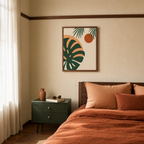 The Second Light monstera print: unframed print is shown framed for styling in a rust linen bedroom; frame not included