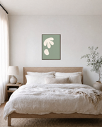 Cream Cutouts Sage unframed print is shown framed for styling in a bedroom; frame not included