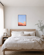 Peach Dune Blue Press edition unframed print is shown framed for styling in a bedroom; Frame not included