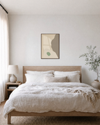 Pale Peach Against Sage pale peach and sage shapes wall art print: unframed print is shown framed for styling in a bedroom; frame not included