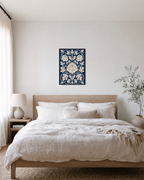 Three Peonies Navy Weave unframed print is shown framed for styling in a bedroom; frame not included