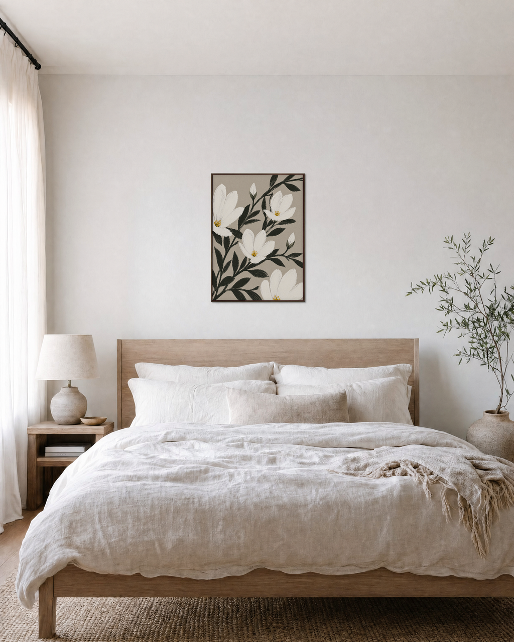 Uneven Magnolias white magnolia wall art: unframed print is shown framed for styling in a bedroom; frame not included