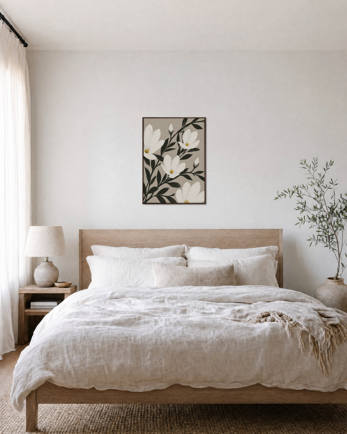 Uneven Magnolias white magnolia wall art: unframed print is shown framed for styling in a bedroom; frame not included
