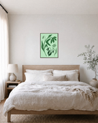 Green Wildflower unframed print is shown framed for styling in a bedroom; frame not included