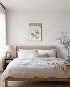 After Tea olive oil wall art: unframed print is shown framed for styling in a bedroom; frame not included
