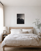 Charcoal Ridges unframed print is shown framed for styling in a bedroom; frame not included