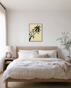 Diagonal Fruiting Branch fruiting branch silhouette wall art print: unframed print is shown framed for styling in a bedroom; frame not included