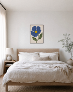 Blue Bloom blue flower art prints: unframed print is shown framed for styling in a bedroom; frame not included