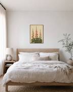 Hollyhock Towers hollyhock wall art: unframed print is shown framed for styling in a bedroom; frame not included