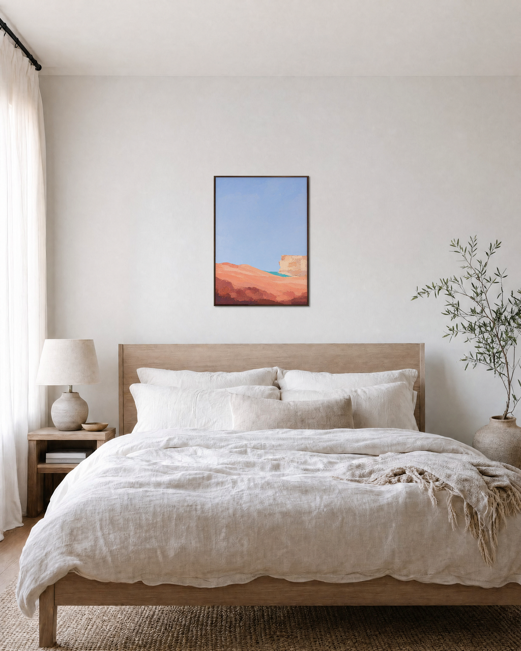 Coral Dune Below Blue Sky blue and coral abstract wall art print: unframed print is shown framed for styling in a bedroom; frame not included