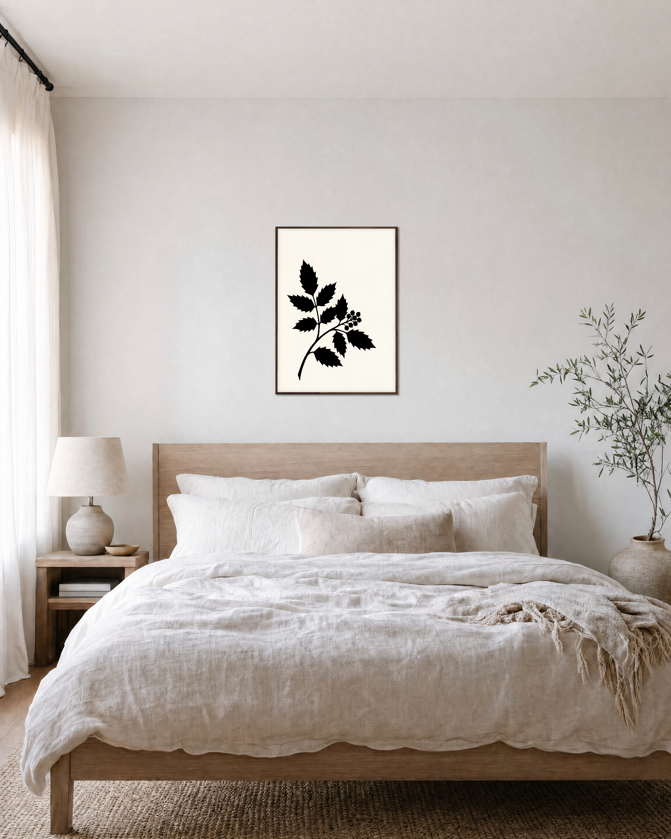 Black Leaf Sprig unframed print is shown framed for styling in a bedroom; frame not included