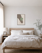 Taupe Curve with Sage Oval taupe and sage abstract wall art: unframed print is shown framed for styling in a bedroom; frame not included