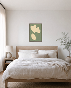 Cream Cutouts Sage unframed print is shown framed for styling in a bedroom; frame not included