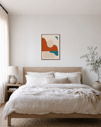 Terracotta Horizon with Teal Marks burnt orange mid century wall art: unframed print is shown framed for styling in a bedroom; frame not included