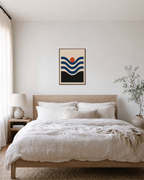 Coral Nest navy wave coral wall art: unframed print is shown framed for styling in a bedroom; frame not included