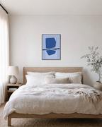 Twin Tide navy blue geometric wall art: unframed print is shown framed for styling in a bedroom; frame not included