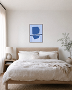 Azure Reflection unframed print is shown framed for styling in a bedroom; frame not included