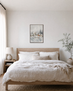 Snow Village mist village print: unframed print is shown framed for styling in a bedroom; frame not included