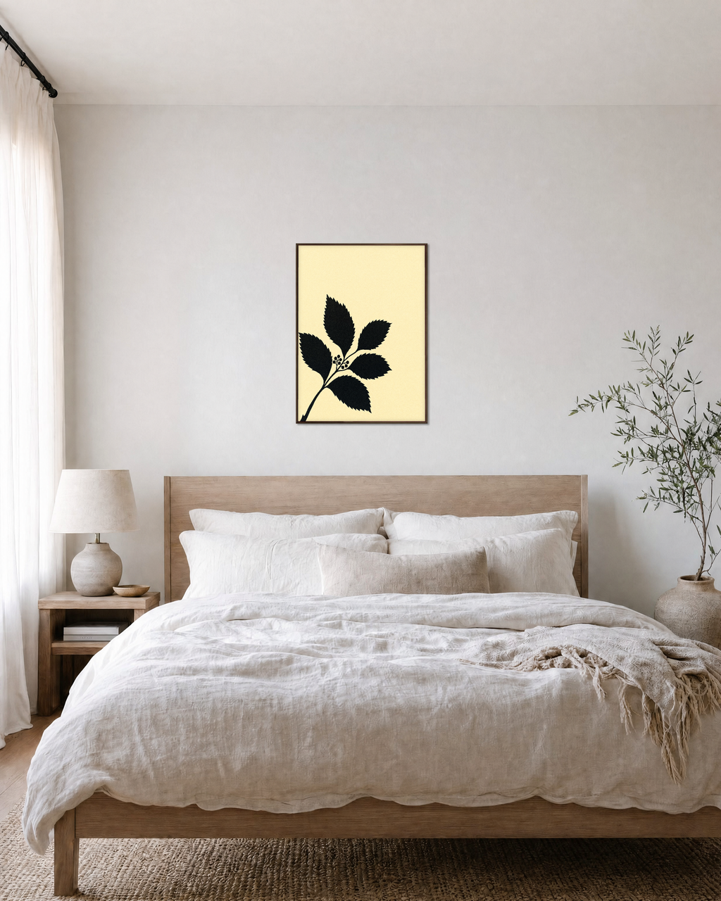 Black Leaf Sprig unframed print is shown framed for styling in a bedroom; frame not included