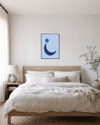 Blue Crescent unframed print is shown framed for styling in a bedroom; frame not included