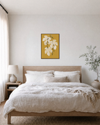 Sheer Fig Leaves Mustard unframed print is shown framed for styling in a bedroom; frame not included