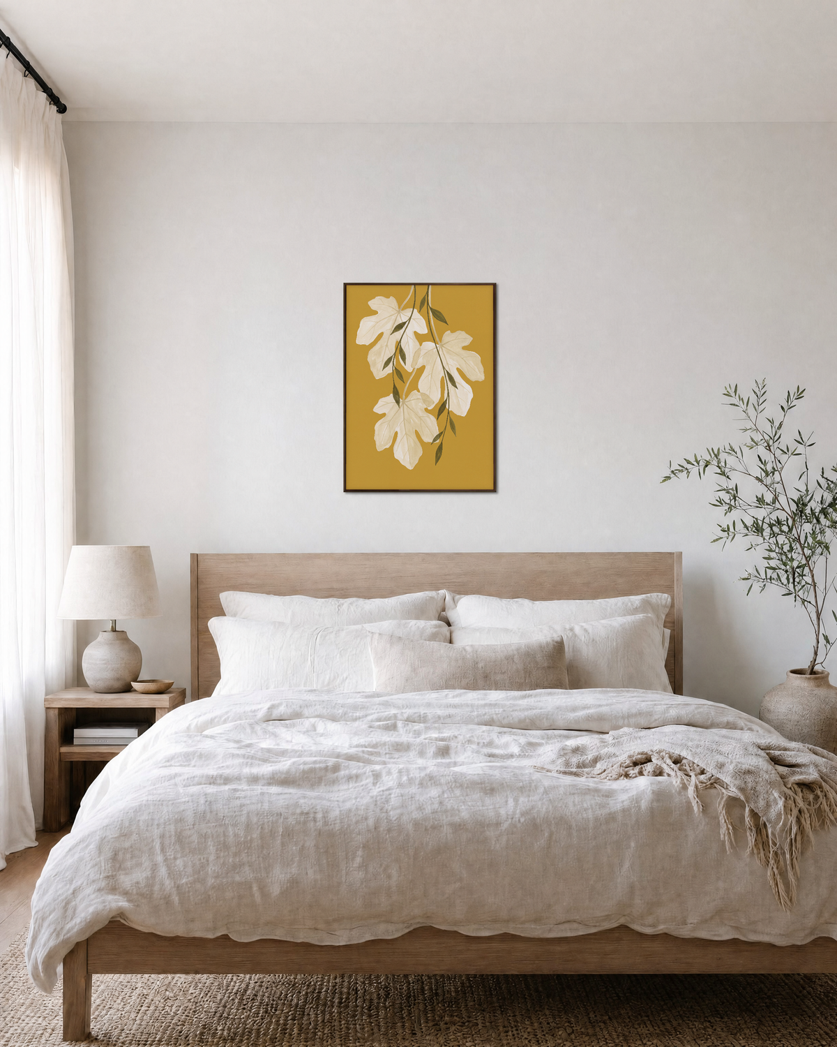 Sheer Fig Leaves Mustard unframed print is shown framed for styling in a bedroom; frame not included