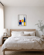 Primary Still Life Grid Remap unframed print is shown framed for styling in a bedroom; frame not included