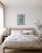 Reef Trio blue fish wall art: unframed print is shown framed for styling in a bedroom; frame not included