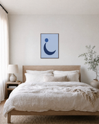 Navy Crescent with Blue Circle blue moon wall art: unframed print is shown framed for styling in a bedroom; frame not included