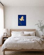 Dove Branch Blue unframed print is shown framed for styling in a bedroom; frame not included
