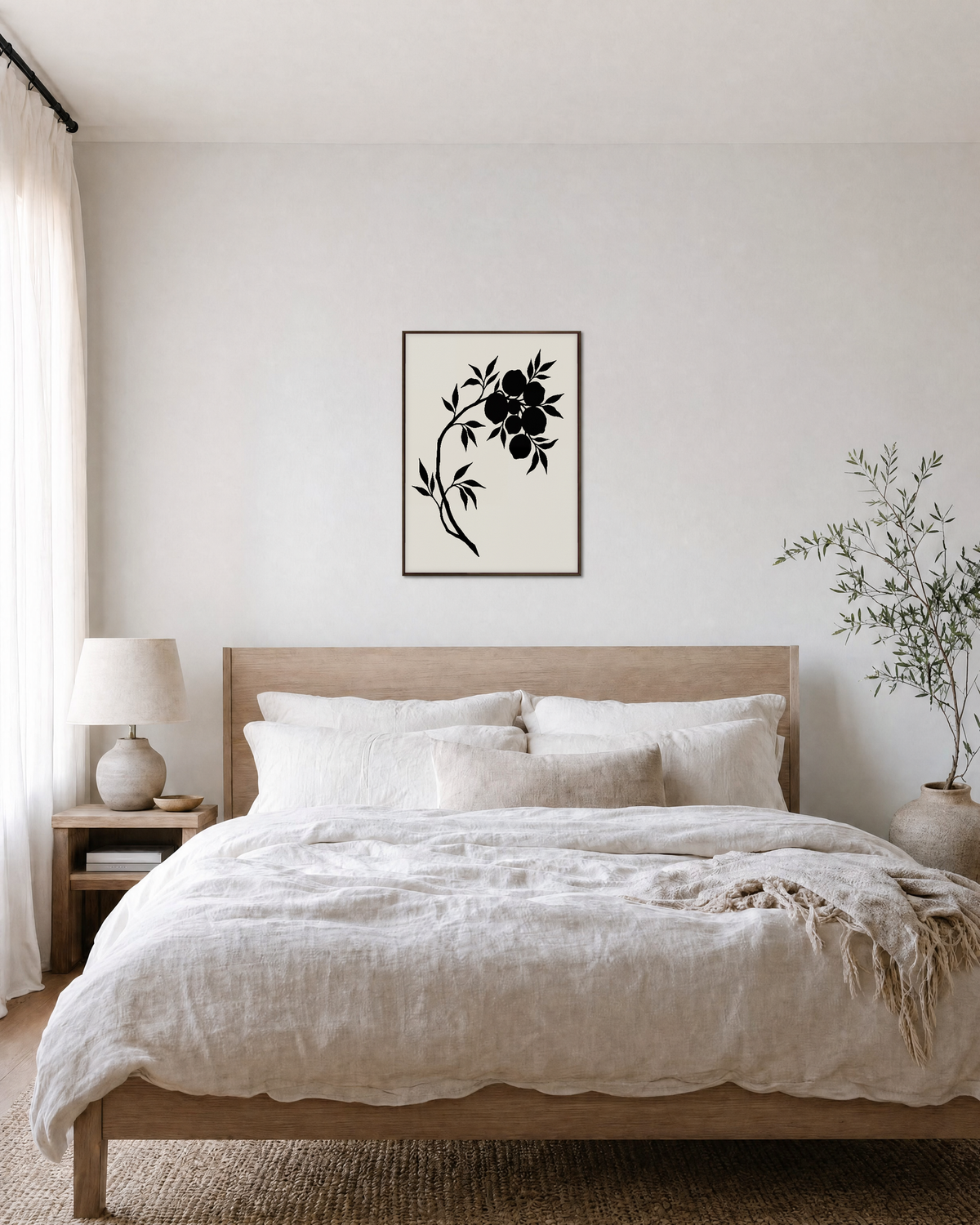 Black Leaves and Fruit black botanical silhouette wall art print: unframed print is shown framed for styling in a bedroom; frame not included