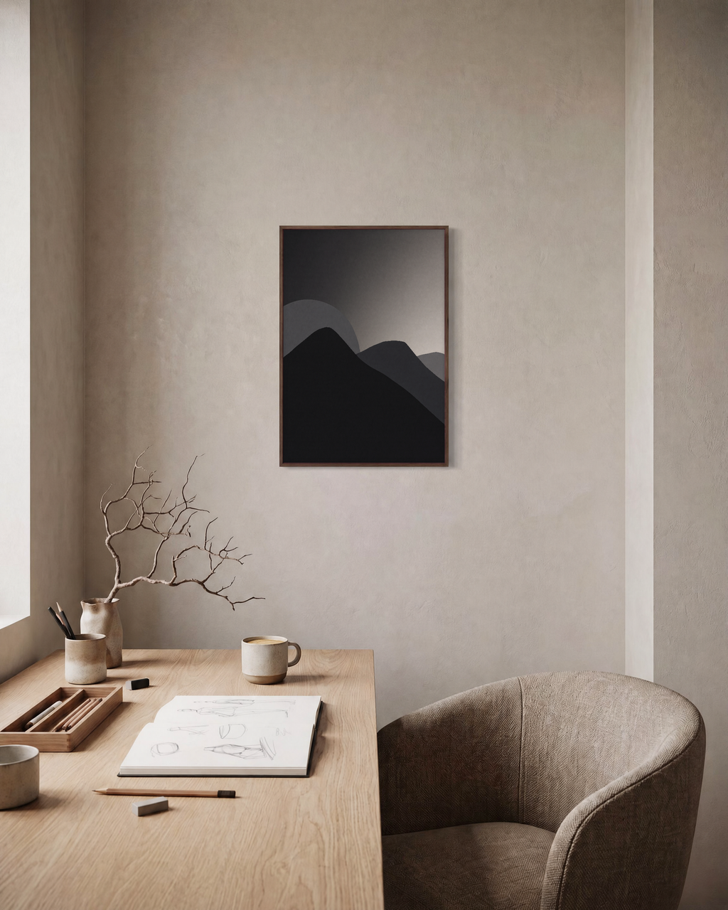 Black Peaks with Pale Sun minimalist mountain silhouette wall art print: unframed print is shown framed for styling in a home office; frame not included