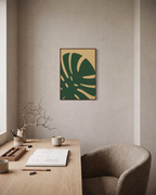 Monstera Cut monstera leaf wall art: unframed print is shown framed for styling in a home office; frame not included