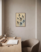 Passing Swallows bird art print: unframed print is shown framed for styling in a home office; frame not included